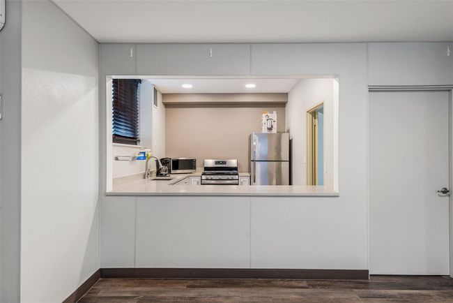 Kitchen featuring stainless steel appliances, a sink, recessed lighting, light countertops, and dark wood-type flooring | Image 18