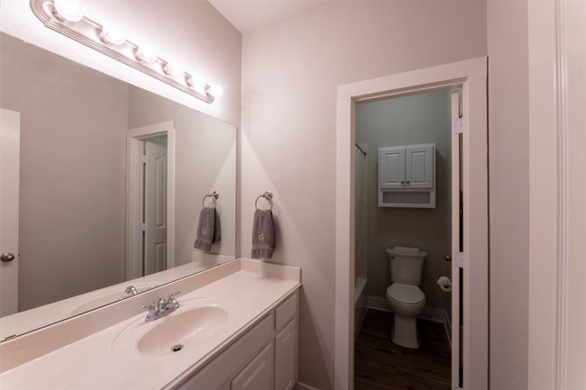 Full bath with vanity, wood finished floors, and tub / shower combination | Image 33
