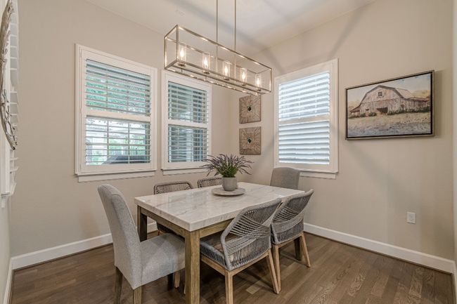 Dining room featuring a chandelier, baseboards, and dark wood-type flooring | Image 17