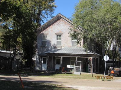 View of front of property with a front yard and a porch | Image 1