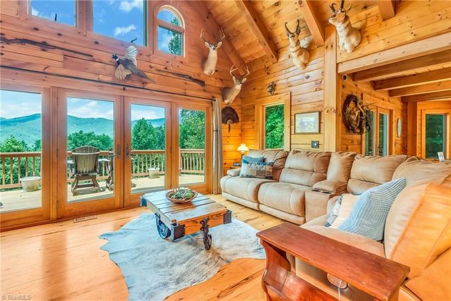 Imagine cooking in the all-wood cabin with granite countertops and a large island, surrounded by stunning long-range mountain views. | Image 21