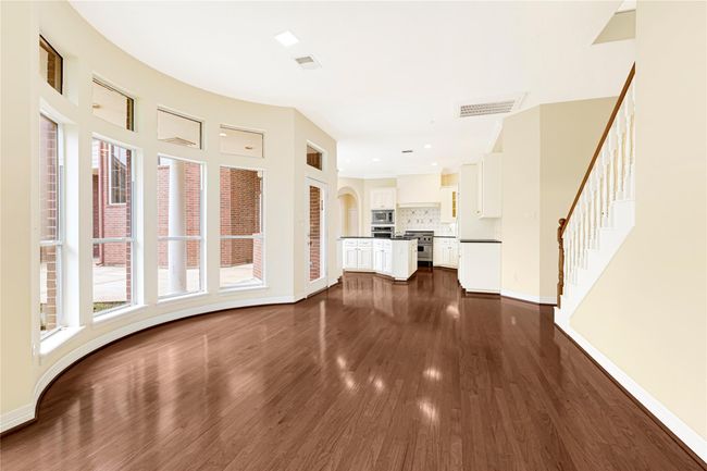 Bright and inviting breakfast area with expansive windows and elegant hardwood floors. | Image 21