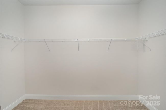 Oversized Primary Bedroom's walk-in closet with ample storage | Image 19