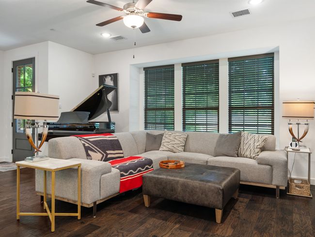 Living room with ceiling fan, wood finished floors, recessed lighting, and baseboards | Image 11