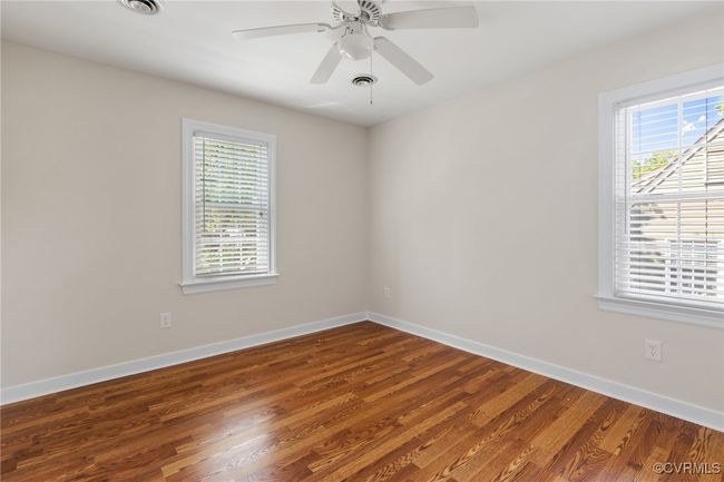 Bedroomo 3 with plenty of natural light, laminated wood flooring, closet and ceiling fan with light. | Image 32