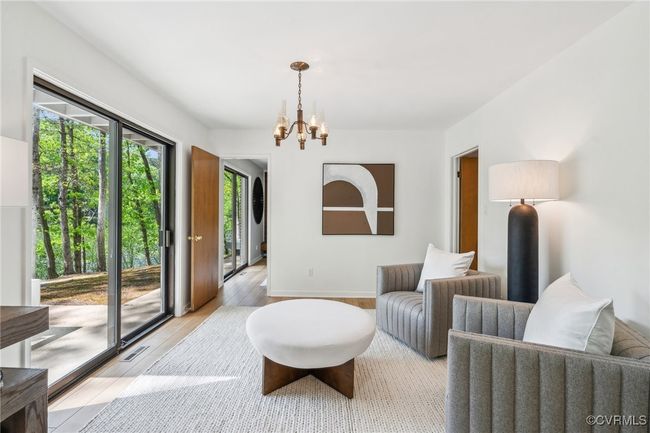 Sitting room with a chandelier, light wood-style flooring, and visible vents | Image 21
