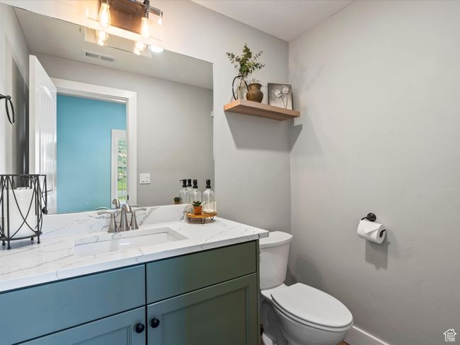 Bathroom featuring toilet and vanity | Image 21