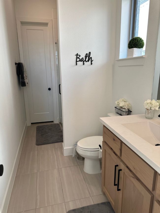 Bathroom featuring baseboards, vanity, and toilet | Image 28