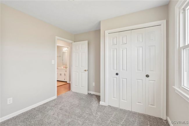 Unfurnished bedroom with carpet flooring, a closet, and baseboards | Image 19