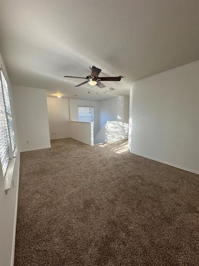 Spare room with plenty of natural light, a ceiling fan, and carpet | Image 8