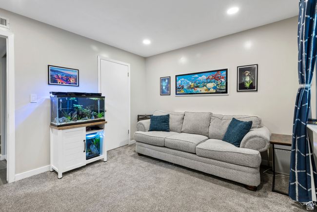 Carpeted living area with recessed lighting and baseboards | Image 19