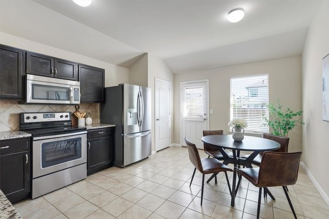 A sizable pantry is found at the back of the kitchen. | Image 9