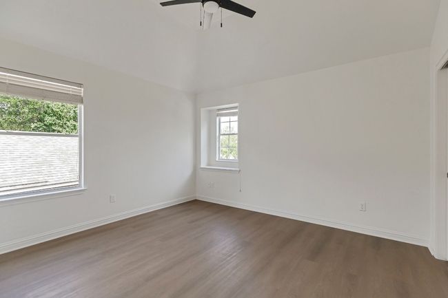 Empty room featuring wood finished floors and a ceiling fan | Image 21