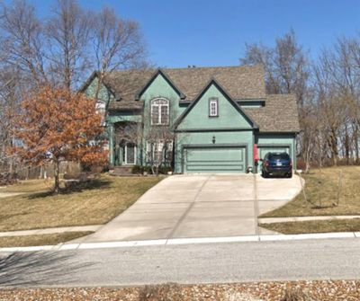 View of front of property with a front yard and a garage | Image 1