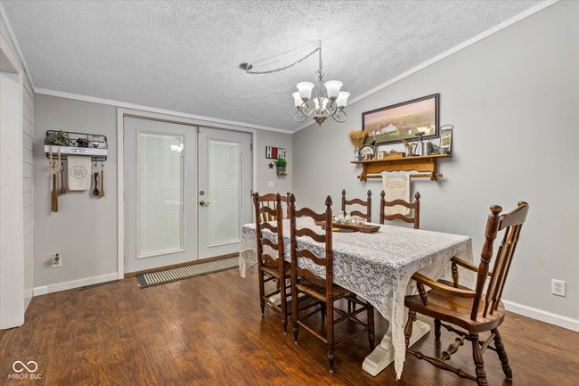 A formal dining room adjoins the kitchen and the massive great room. | Image 14