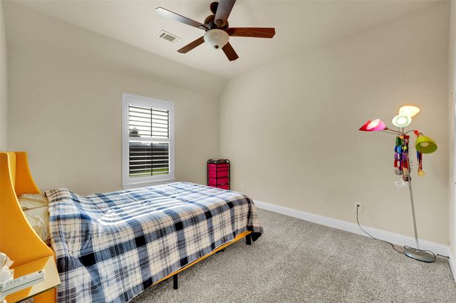 Bedroom with carpet floors, vaulted ceiling, and a ceiling fan | Image 23