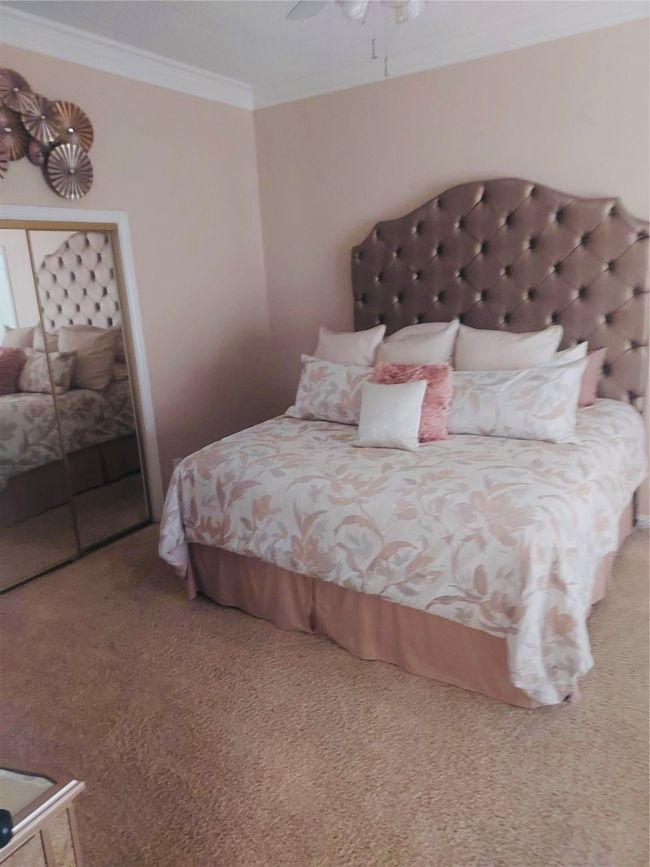 Owner's Ensuite features a huge bedroom with crown molding and plenty of natural light. | Image 22