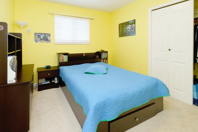 Carpeted bedroom with a closet | Image 26