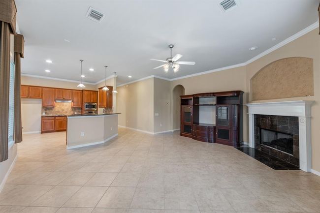 The open layout seamlessly connects the kitchen to the living room, creating a spacious and airy environment perfect for entertaining and everyday living. | Image 28