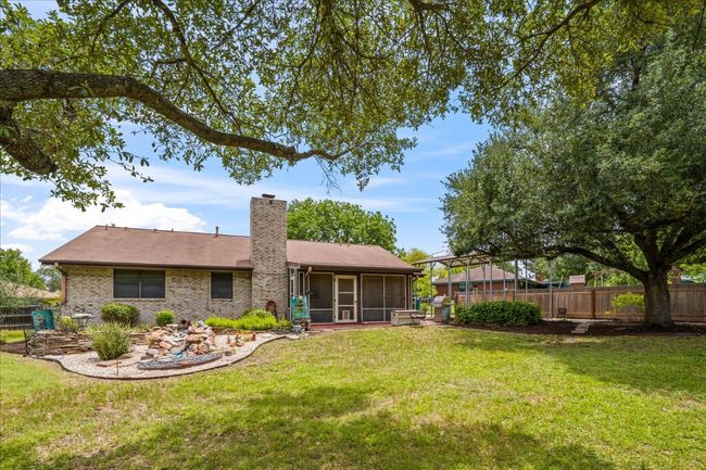 Back of house with a sunroom and a chimney | Image 27