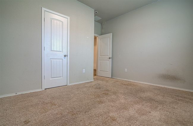 Unfurnished bedroom with visible vents, baseboards, and carpet floors | Image 5