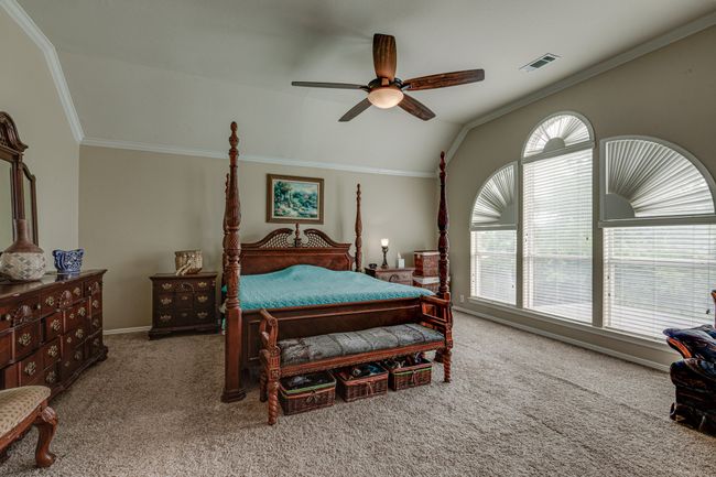Bedroom with carpet floors, lofted ceiling, ornamental molding, and ceiling fan | Image 24