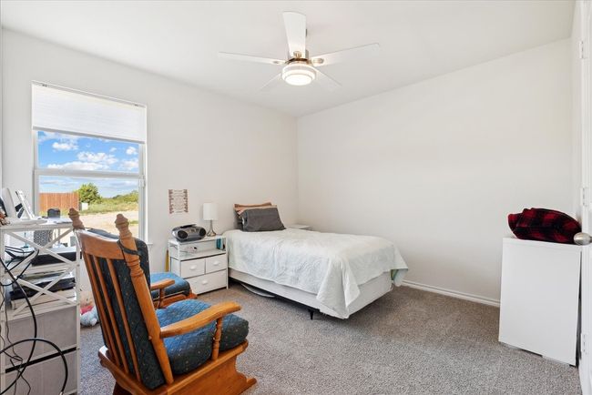 Bedroom with carpet floors and ceiling fan | Image 7