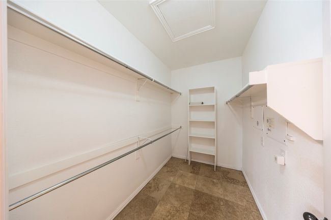 Walk in closet featuring attic access | Image 22