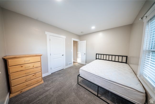 Bedroom with carpet and multiple windows | Image 16