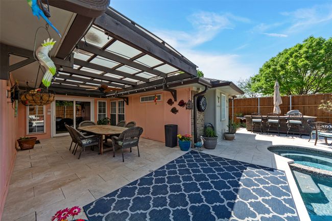 View of patio / terrace featuring fence, a pergola, an in ground hot tub, and outdoor dining area | Image 6