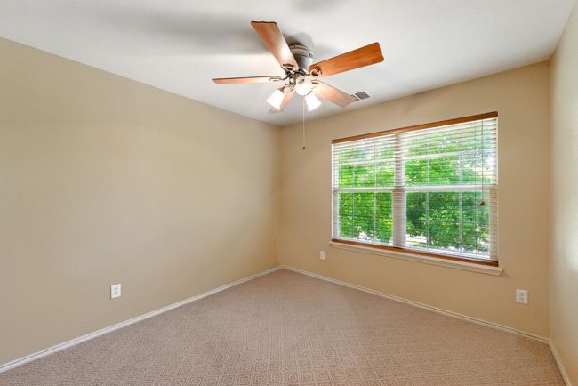 Carpeted spare room featuring baseboards and ceiling fan | Image 25