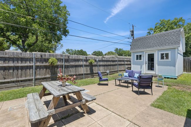 Fenced backyard with an outdoor hangout area, a patio, she shed structure, and outdoor dining space | Image 27