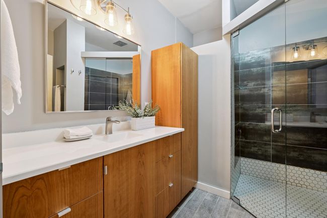 Custom Cherry wood vanity and storage cabinets featuring soft close hinges. | Image 12