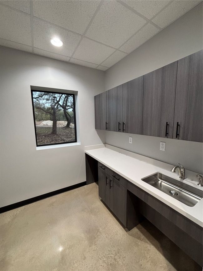 Unfurnished office featuring a sink, baseboards, and a paneled ceiling | Image 4