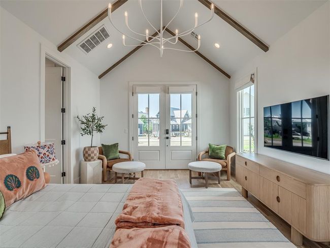 Bedroom with access to exterior, french doors, wood finished floors, multiple windows, and recessed lighting | Image 22