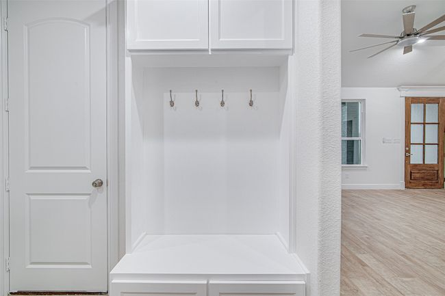 Mudroom featuring a ceiling fan, wood finished floors, and baseboards | Image 28