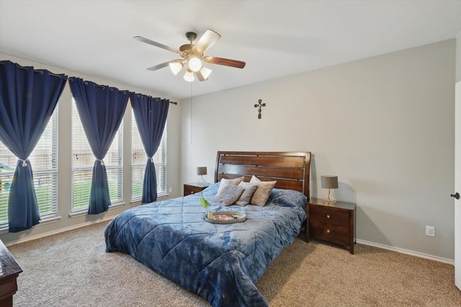 Bedroom with carpet, baseboards, and a ceiling fan | Image 17