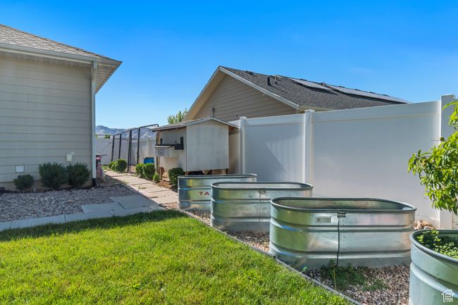 View of side of home with roof with shingles | Image 33