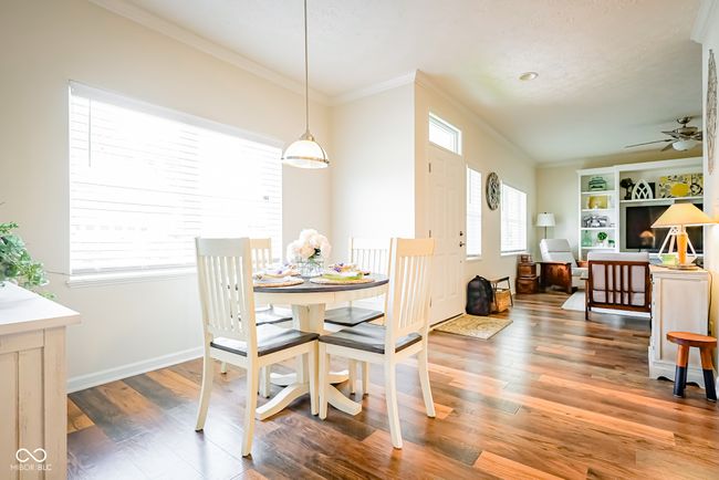 dining area featuring ornamental molding, a ceiling fan, wood finished floors, and baseboards | Image 13