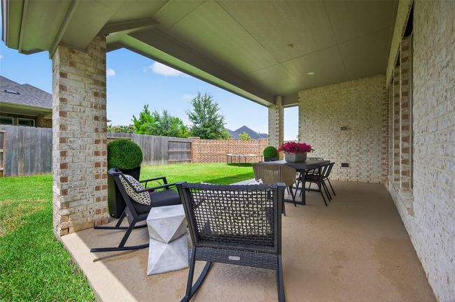 Spacious patio framed by brick columns and open lawn, perfect for entertaining or enjoying quiet evenings. A great extension of the home's indoor-outdoor living potential. | Image 30