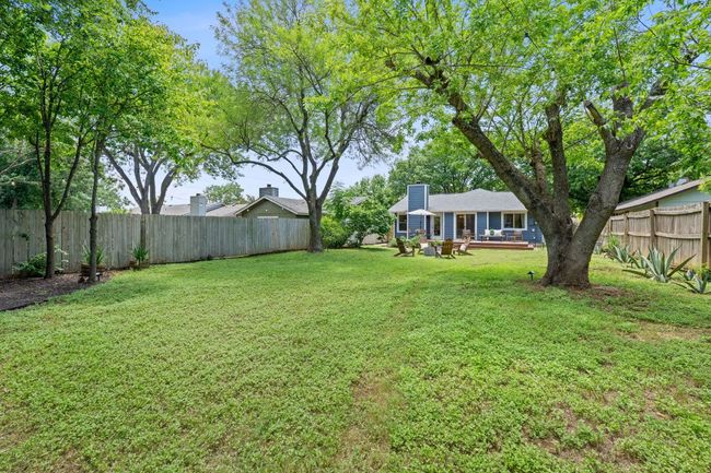 Fenced backyard with a patio | Image 37