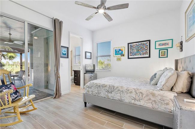 Bedroom featuring access to exterior, baseboards, a ceiling fan, and wood tiled floor | Image 43