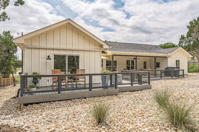 Back of property featuring a private patio for the primary bedroom. | Image 26
