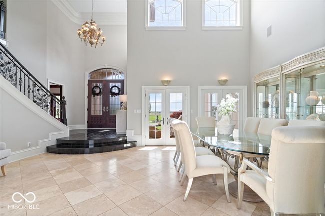 Formal dining room opens up to an outdoor patio. | Image 10
