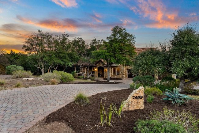 Front entrance to the driveway, surrounded by native trees and plants. | Image 4