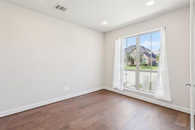 A quiet and private study with double French doors and large windows, perfect for working from home or reading in peace. | Image 7