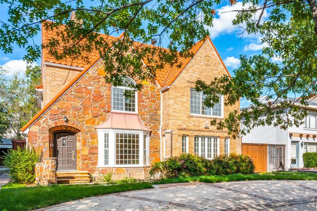 English style home featuring brick siding and stone siding | Image 36