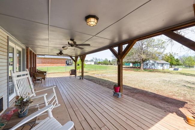 Deck with a lawn, fence, and a ceiling fan | Image 35