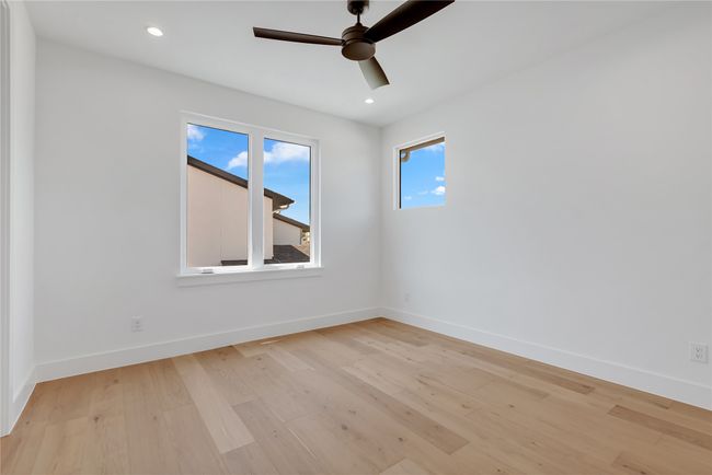 Spare room featuring a ceiling fan, light wood finished floors, and recessed lighting | Image 33