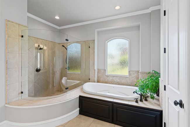 Full bathroom with a tile shower, crown molding, recessed lighting, tile patterned floors, and a jetted tub | Image 21